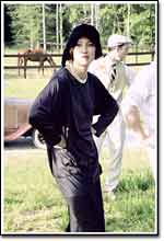 Chloe (Natane Boudreau) struts in the fields surrounding the 1920s  "Pink House."